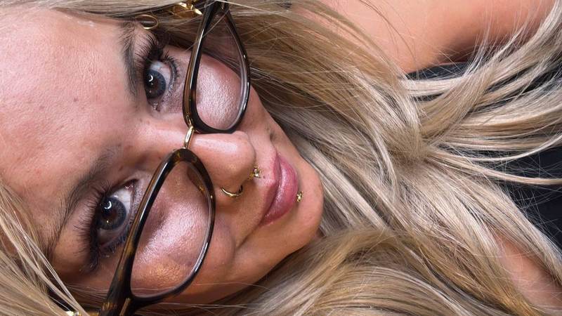 BBW Brazilian Goddess Maya3ee Rainha close-up — tortoise glasses, gold piercings, soft smile