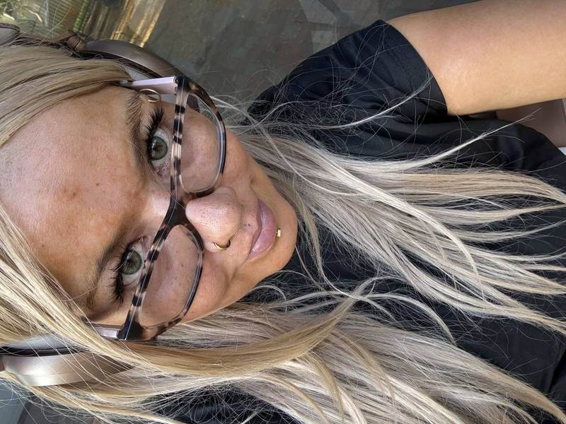 BBW Brazilian Goddess Maya3ee Rainha — tortoise glasses, headphones, blonde hair, outdoor smile